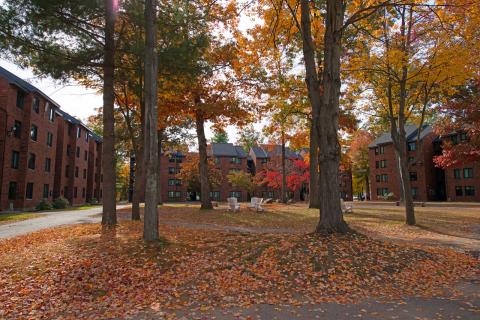 Apartment Complex arranged in a horseshoe shape, surrounded by fall foliage.