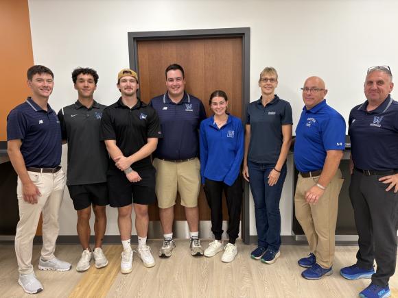 Five Westfield State students stand with three faculty and staff members from the Athletic Training program.