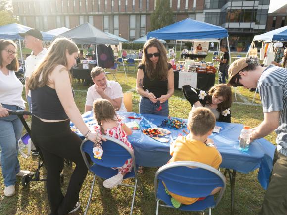 People work around a table doing art projects