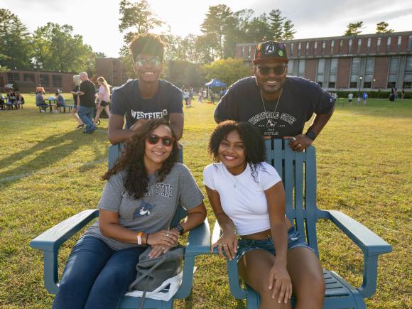 Family wearing Westfield State shirts on campus green