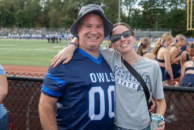 Student smiling with parent at Family Weekend.