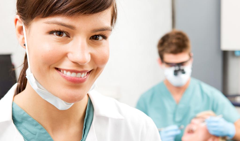Dental Assistant with mask and med coat