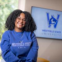 Dianyeliz Ozuna Sandoval, president of the Class of 2026. She's wearing a blue sweatshirt and poses in front of a white wall.